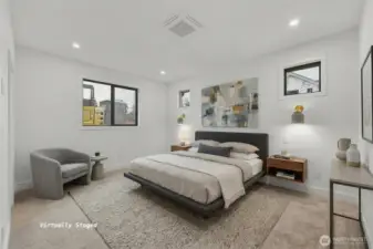 The main floor primary is spacious (virtually staged)