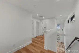 The upstairs landing area showing the 2 bedrooms and shared full bath.