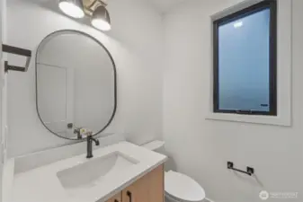 Main floor half bath, located just off of the kitchen area, near the garage.