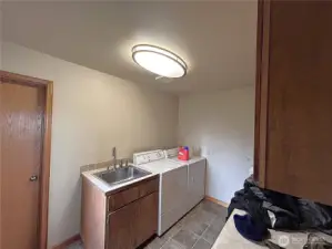 Laundry room with folding table, custom cabinets and sink