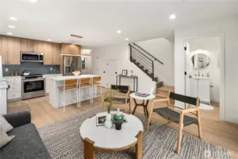 Open concept living includes convenient powder room and open staircase