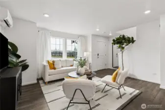 Open-concept great room filled with natural light from large windows, creating a bright and welcoming living space.