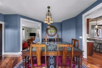Dining room located off the kitchen, drenched in natural light through the large windows that surround overlooking back yard