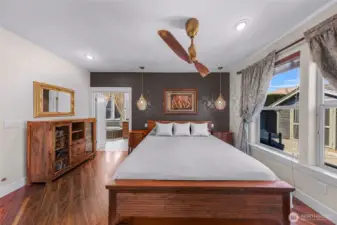 The primary bedroom located on the main level is very spacious adorned with custom ceiling fan and accent lighting