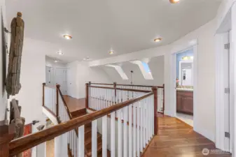 Heading to the second open to the lower level, filled with bright light and walnut flooring