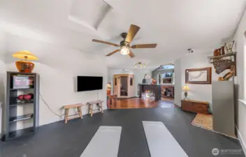 View from far wall of bonus room, currently being used for yoga, play space, office and health retreat with sauna included in the sale of the home.