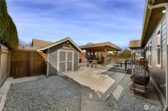 Opposite side of back yard, continues with being fully fenced and recently stained, large shed has plenty of storage and all the electrical for your incredible outdoor living space.