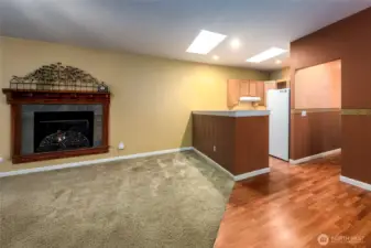 Living Room with fireplace and open concept to the kitchen.