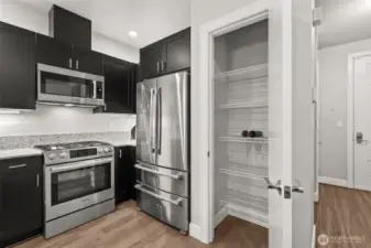 Generous sized pantry offers extra storage. "Pizza-sized" refrigerator is like-new.