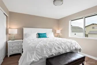 The spacious primary bedroom features a generous closet and a private ensuite bath, complete with a new shower, modern vanity, updated flooring, and stylish lighting—your own personal retreat.