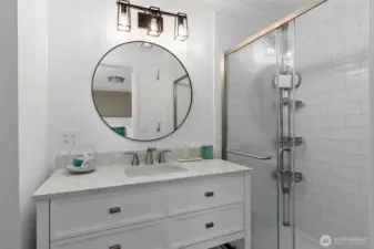 The primary bathroom has been completely updated with all-new flooring, a sleek shower, modern vanity, toilet, and stylish lighting—offering a fresh, contemporary feel from top to bottom.