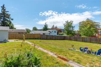 The fenced backyard includes a spacious patio area and plenty of room to bring your outdoor dreams to life—perfect for entertaining, gardening, or simply relaxing in privacy.