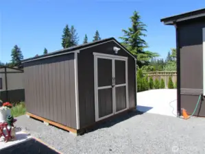 SHED W/ PWR/ SELFS, LOCATED AT END OF DRIVEWAY AREA.