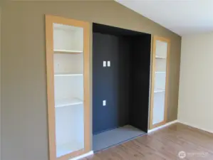 LARGE RECESSED MEDIA AREA WITH BUILT-IN SHELVING ON BOTH SIDES IN FAMILY ROOM.