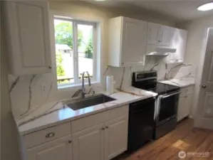 NEW COUNTER TOPS W/ BACKSPLASH ACCENT, UPDATED APPLIANCES/ SINK AND 3 SKYLIGHTS.