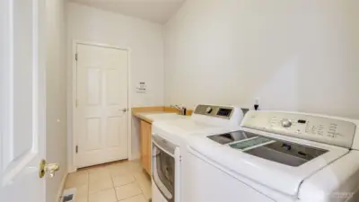 Enjoy the convenience of a private laundry room featuring a sink, extra storage, direct access to the garage, and included washer and dryer!