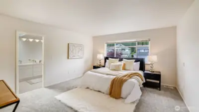 The primary bedroom features a spacious, open layout perfect for your personal design touch, with plenty of natural light streaming in. It also includes a connected en suite bathroom for added convenience