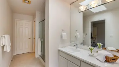 This sleek, modern bathroom features a spacious walk-in shower and a separate toilet area for added comfort and privacy