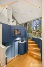 From the entry, a spiral staircase leads up to the lofted primary suite