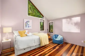 The secondary bedrooms share their own wing. Mixed species hardwood floors, vaulted ceilings, and amazing light are featured in bedroom #2.