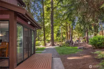 Downstairs, the deck outside the dining room leads to the peaceful, fenced backyard sanctuary