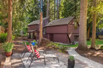 From the deck, a gravel pathway leads to a lovely patio area...