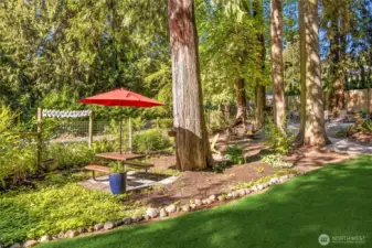 Level lawn area and another lovely dining/picnic space to enjoy the peaceful setting