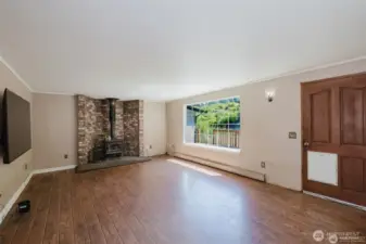 living room with woodstove and picture window
