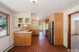 practical Galley like kitchen. Sink to left and fridge and place for range on the right.