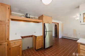 old range was removed. Outlet for electric range. Stainless steel fridge stays
