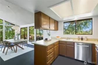 The spacious kitchen celebrates its original mid-century character, remarkably intact and undamaged—a rare find that many will treasure—while the floor plan also allows for easy future expansion to embrace even more of the views.