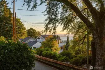 Puget Sound views from the west slope, with everyday favorites close at hand—Macrina Bakery, Ken’s Market, Good Society Brewery, Trader Joe’s, Metropolitan Market, and Whole Foods all nearby.