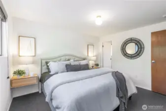 Primary bedroom on the main floor (10’-6” x 12’-8”), one of three bedrooms in a quiet wing, complete with en suite bath.”