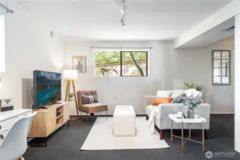 Garden Level living/dining area (12’-6” x 27’-0”) with full-size windows and garden outlooks, adaptable as media lounge, office hub, or potential ADU living room.