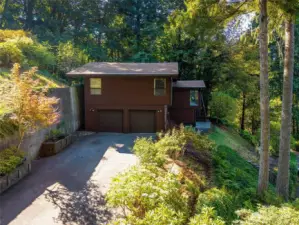 Pulling up to the house and the 2 car garage, front door entrance on the left