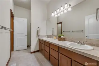 Mother in law bathroom with dual sinks, shower and separate toilet area