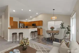 Bright and functional kitchen with ample counter space, breakfast bar seating, and all appliances included. The adjacent dining area opens to the backyard, creating an easy flow for meals and entertaining.