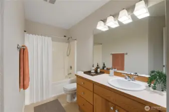 Crisp and clean full bath featuring a large vanity, updated lighting, and a shower/tub combo—freshly styled and move-in ready.