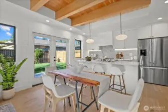 Bright, open concept living with exposed ceiling, easy access to the generous yard, and an abundance of natural lighting.