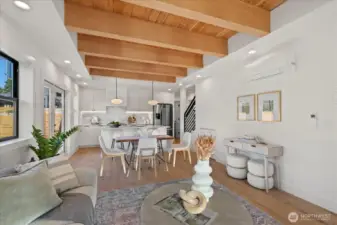 Open concept living, kitchen, dining area with hardwood flooring, air conditioning, and high end finishes.