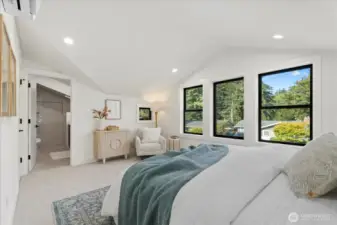 Primary bedroom with tons of natural lighting, elegant vaulted ceilings, and a large walk-in-closet.