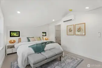 Primary bedroom with tons of natural lighting, elegant vaulted ceilings, and a large walk-in-closet.