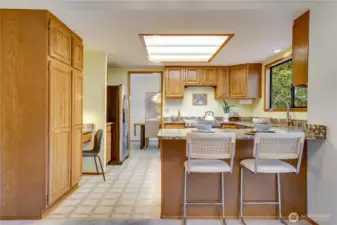 Thoughtfully updated with designer granite, this kitchen blends style and function with efficient cabinetry, a built-in desk area, and a convenient breakfast bar—perfect for busy mornings and meals on the go.