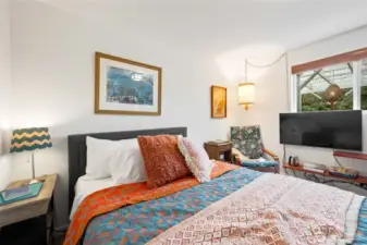 Bedroom 2 upstairs looks into the patio with room for a reading nook and dresser.