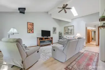You can make several configurations with your furnishings in this spacious living room. Love the vaulted ceilings, skyling, newer laminate wood floors and soft paint. This home is warm and inviting.