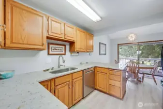 Who doesn't love a spacious kitchen with a lovely view? And a newer dishwasher, granite counters, wood cabinets and easy-to-maintain newer laminate wood floors!