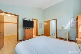 Third view of the primary bedroom which is privately set apart from the two guest bedrooms. A big walk-in closet, 3/4 bath make this a warm, purposeful and spacious ensuite.