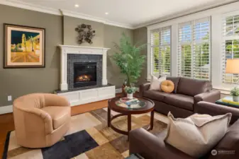 Check out the wall of windows and plantation-style shutters in living room.