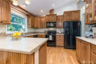 Generous kitchen with rich wood cabinetry
