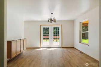 Dining off living room with french doors to deck